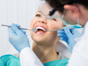 Regular dentist visit. Caries cure. Young woman visiting dentist Regular dentist visit. Caries cure. Young woman visiting dentist